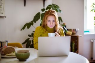 woman working on laptop with coffee