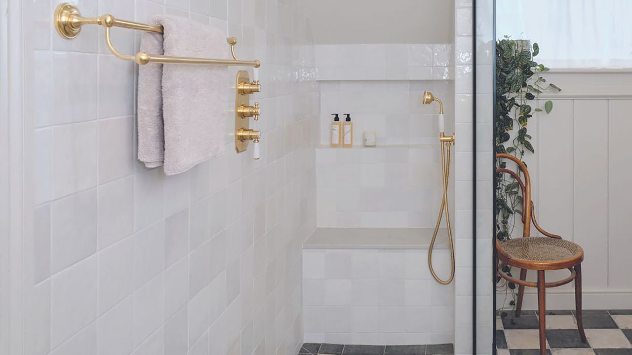 Shower with white tiles and black and white floor tiles