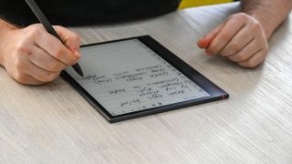 A person writing on the Onyx Boox Note Air 3