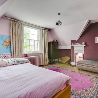 bedroom with pink bed and wooden flooring