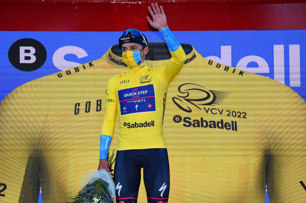 TORRENT SPAIN FEBRUARY 03 Remco Evenepoel of Belgium and Team QuickStep Alpha Vinyl Yellow Leader Jersey celebrates at podium after the 73rd Volta A La Comunitat Valenciana 2022 Stage 2 a 1715km stage from Btera to Torrent VCV2022 on February 03 2022 in Torrent Spain Photo by Dario BelingheriGetty Images