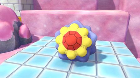 The Pokopia Starmie Doll sits on the floor in Bubbly Basin.