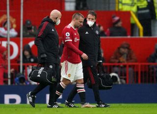 Manchester United’s Luke Shaw walks off injured during the Premier League match at Old Trafford, Manchester. Picture date: Saturday November 6, 2021