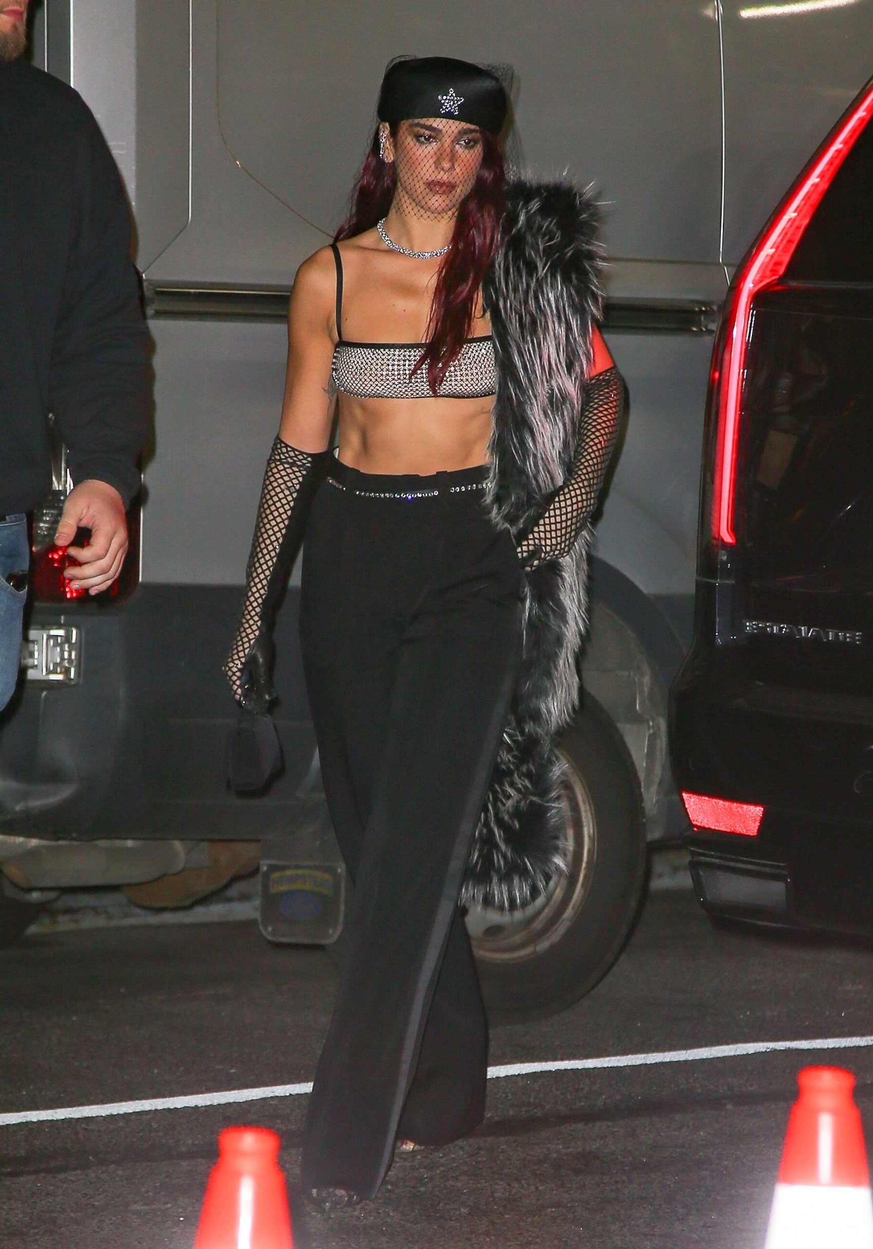 dua lipa wearing a crystal bra top and black pants at the met gala after-party 2024