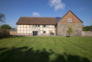 extended barn with timber and brick