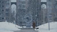 a woman walking through a snowy city scene