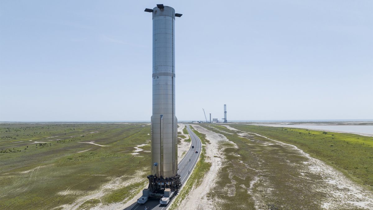 SpaceX&#039;s Booster 7 Super Heavy rocket rolling out to its test pad at Starbase.