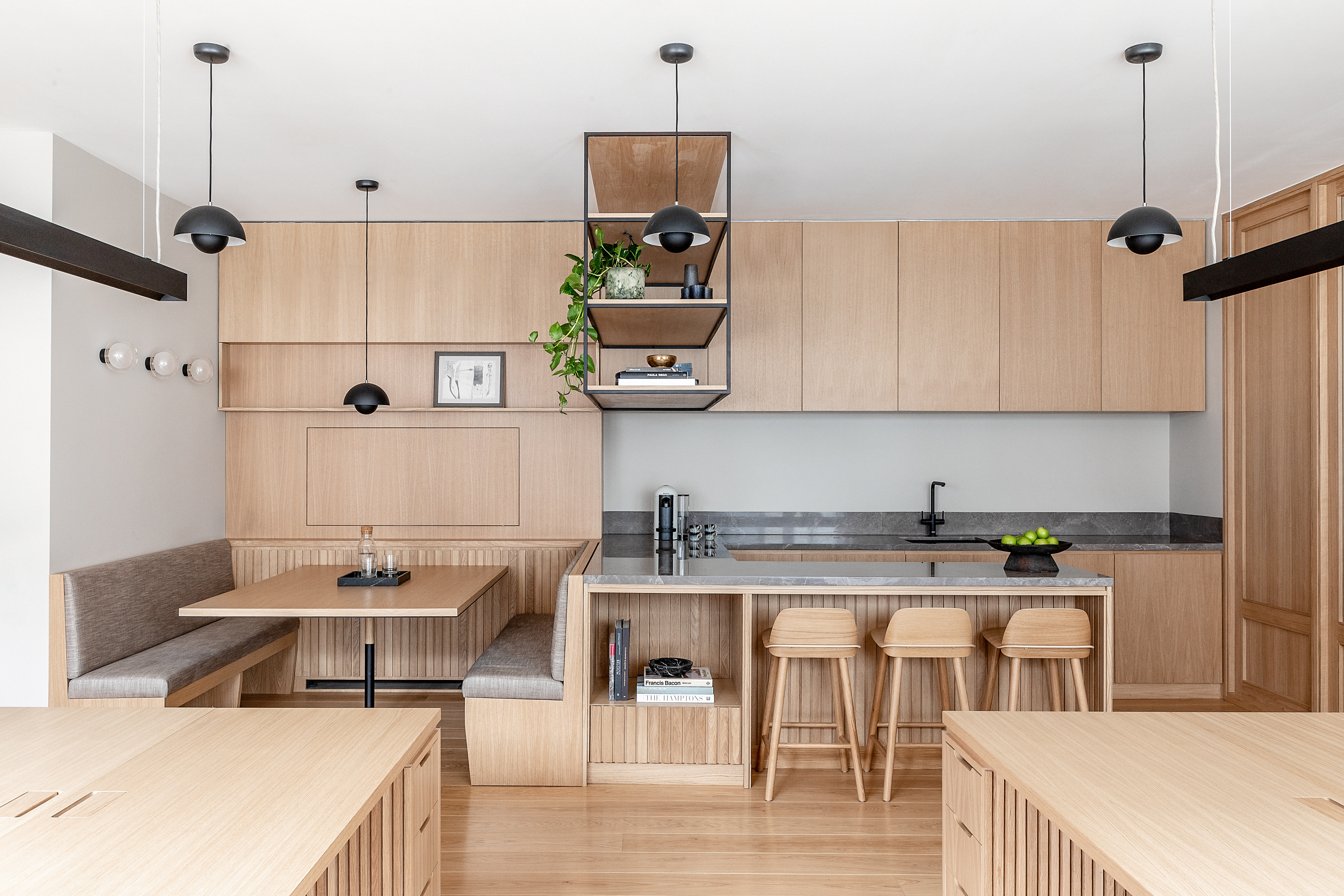 A kitchen island connected to a banquette