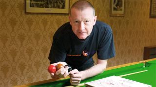 Steve Davis at a snooker table with a pile of prog albums