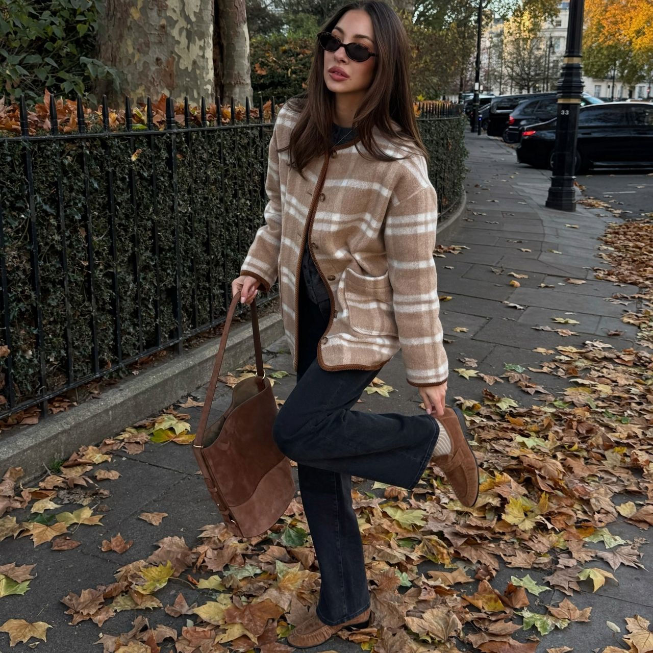 Felicia Akerstrom in a plaid Sezane jacket and suede loafers