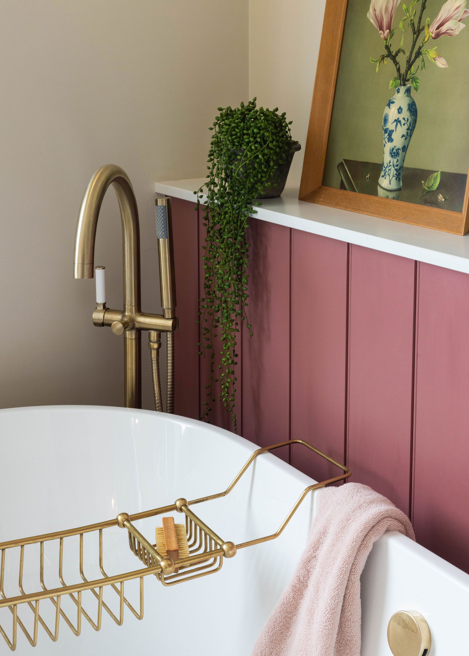 a panelled wall section housing a bathroom's drainage pipes