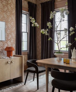 wallpapered dining room with a large floral table display