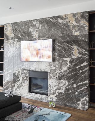 living room tv ideas with flatscreen tv on marble tiled wall