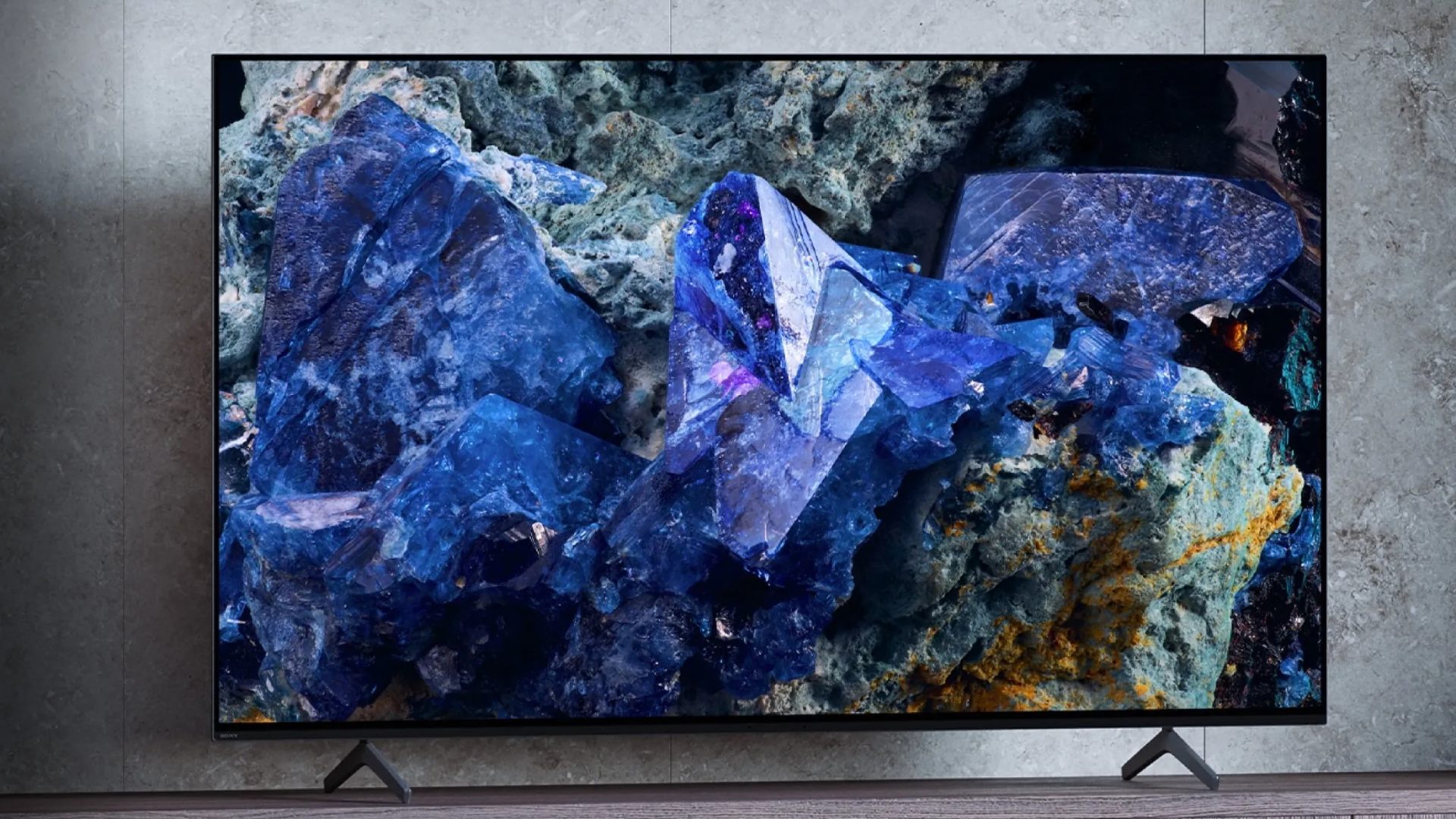 Sony Bravia XR A75L sitting on TV unit with blue crystals on screen