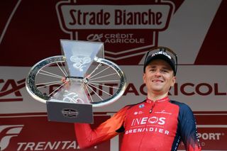 Tom Pidcock with the Strade Bianche trophy in 2023