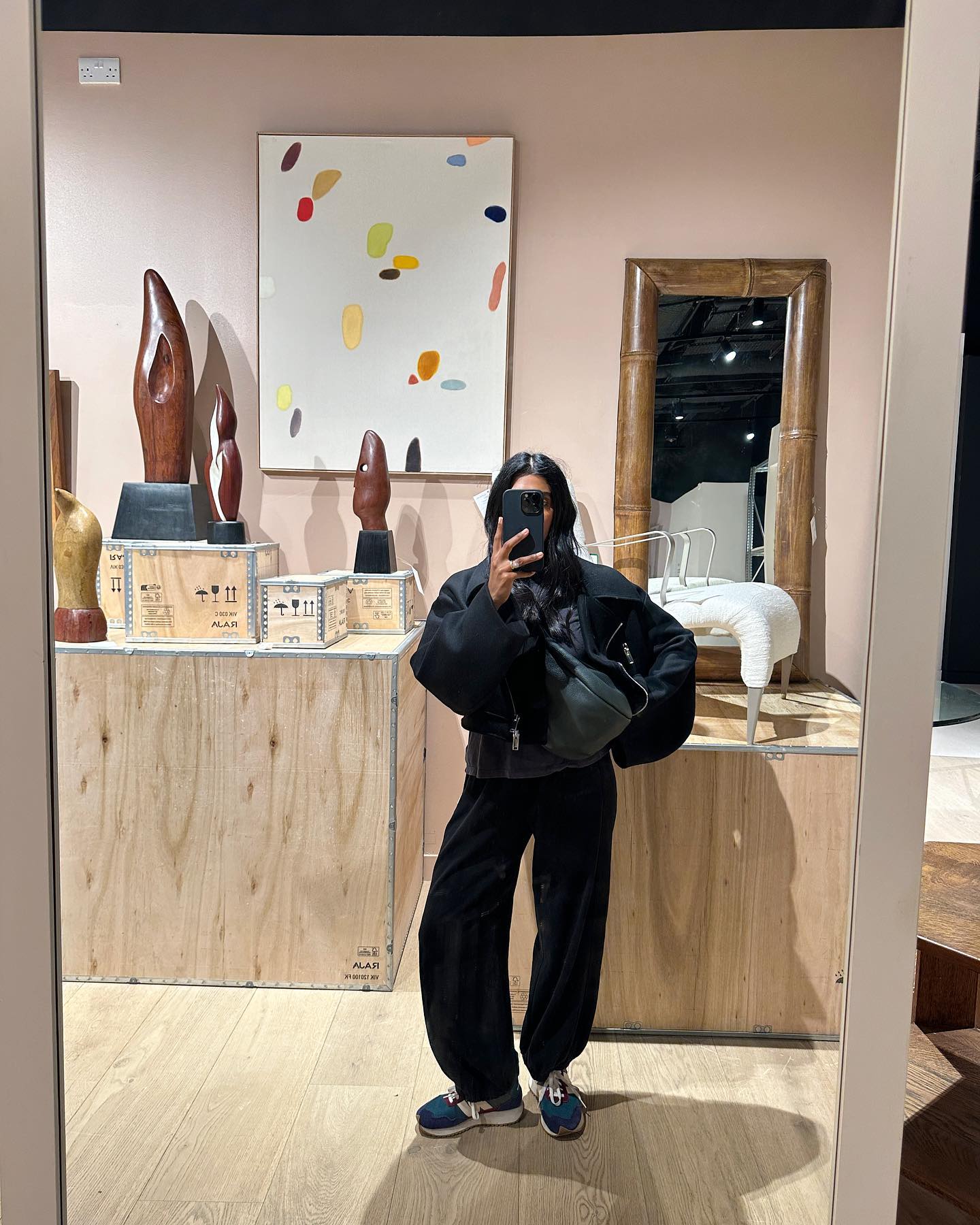 Influencer wears barrel leg trousers.