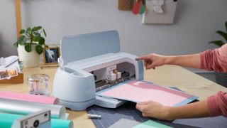 Person using Cricut Maker 3 on craft table