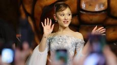 Ariana Grande waves at fans