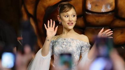 Ariana Grande waves at fans