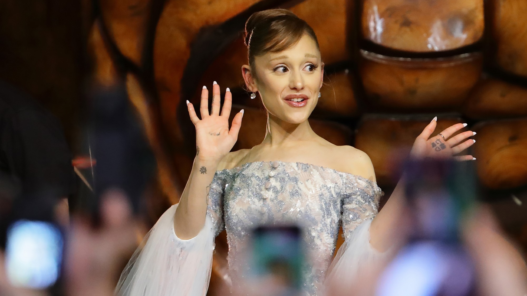 Ariana Grande waves at fans