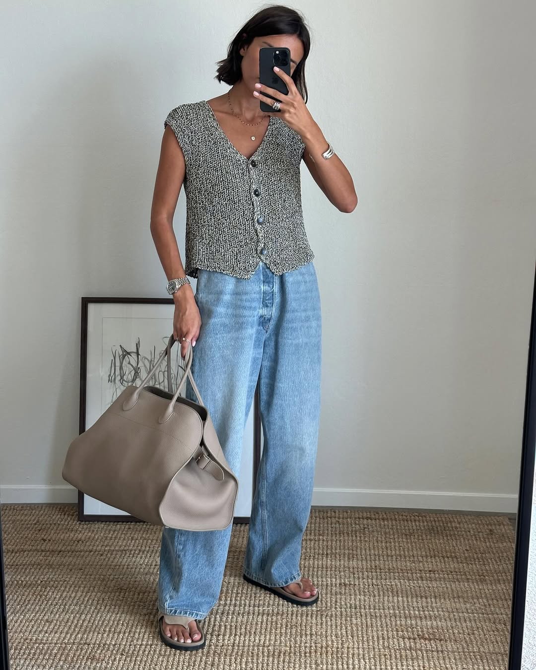 Lison Sebellin in a sweater vest and baggy jeans.