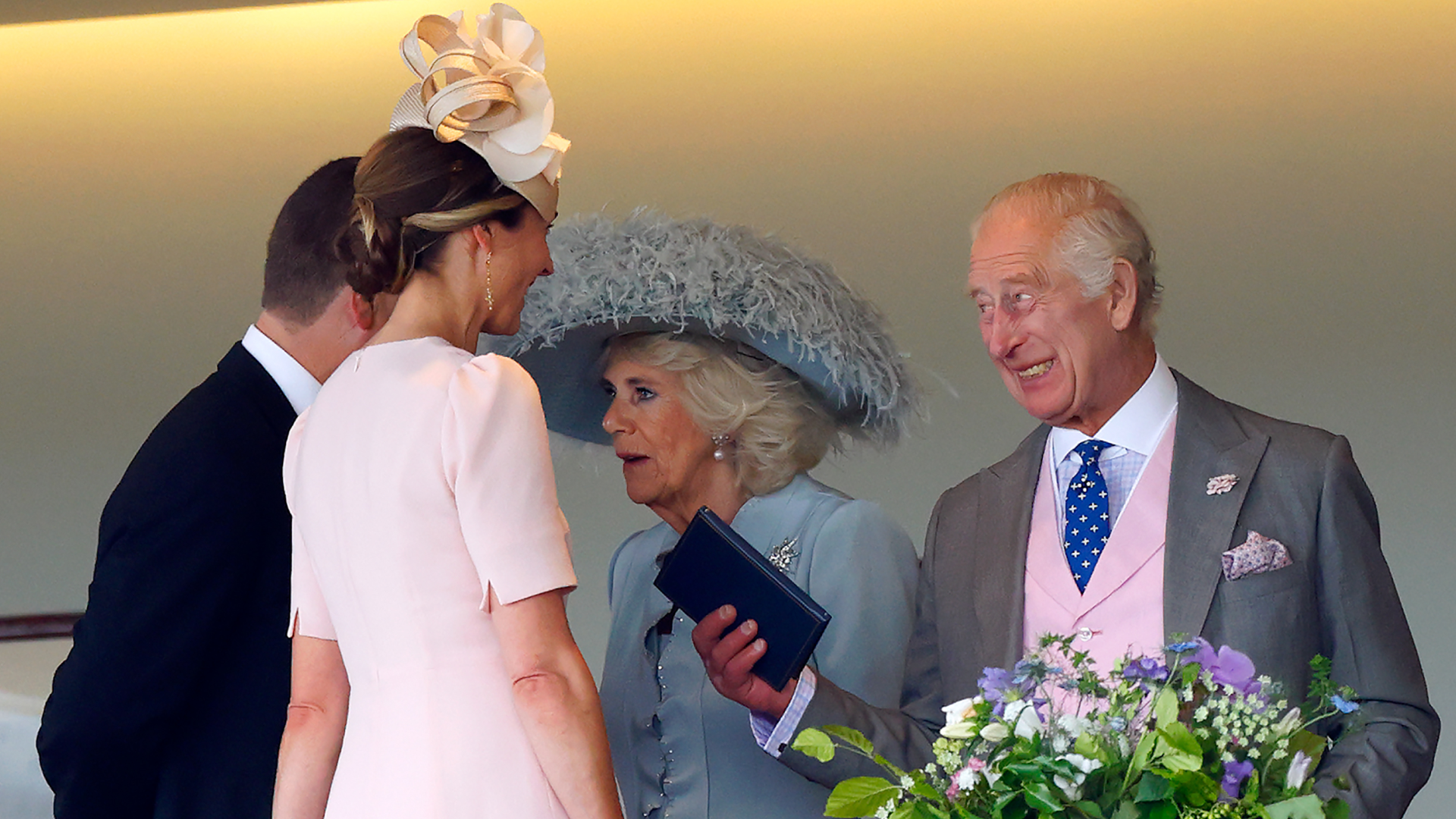 King Charles laughing talking to Harriet Sperling and Peter Phillips