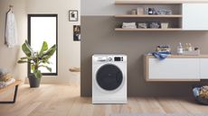 A laundry room with wooden shelves and washer appliance