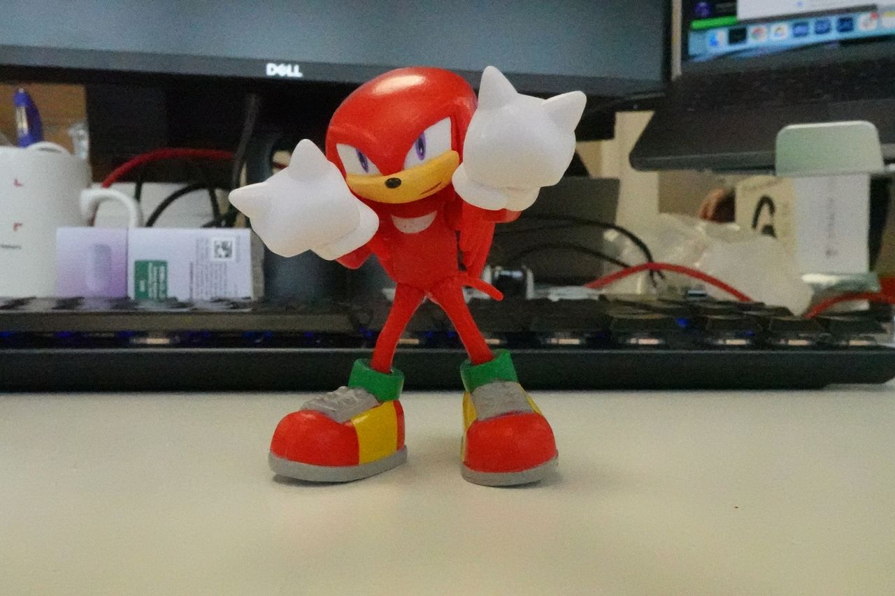 A photo of a red figurine taken on a Sony ZV-1F vlogging camera