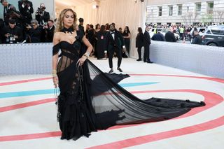 Rita Ora arrives on the Met Gala 2023 red carpet wearing a gothic cut black gown