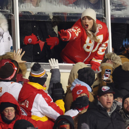 Taylor Swift celebrates with fans during the AFC Wild Card Playoffs between the Miami Dolphins and the Kansas City Chiefs at GEHA Field at Arrowhead Stadium on January 13, 2024