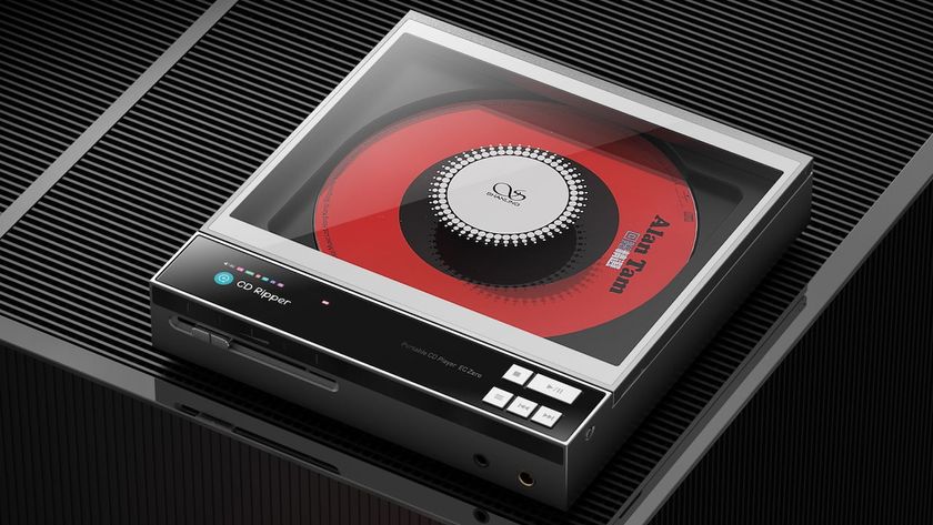 Shanling ECZero AKM on a ribbed dark grey surface with a red CD visible inside the device