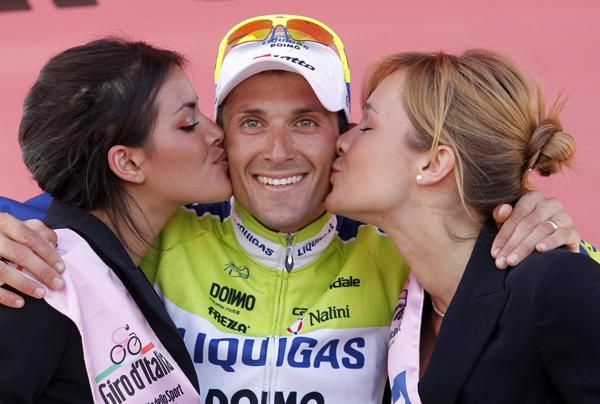 Basso beams as the two podium girls congratulate him