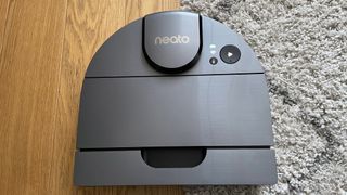 The top of the Neato D10 as it navigates between hard floor and carpet