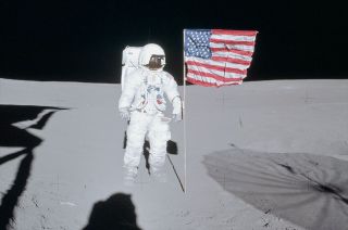 Apollo 14 moonwalker Ed Mitchell poses next to the American flag that he and Alan Shepard planted on the moon in February 1971.