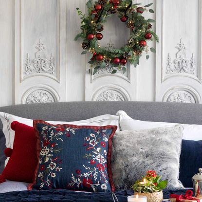 Bed dressed with Christmas bedding and wreath