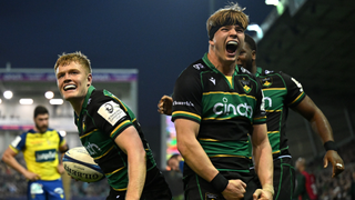 Fin Smith of Northampton Saints celebrates with teammate Henry Pollock after scoring a try during the Investec Champions Cup Round of 16 match between Northampton Saints and ASM Clermont Auvergne at cinch Stadium at Franklin's Gardens on April 04, 2025 in Northampton, England. 