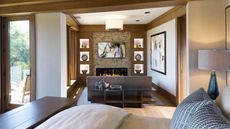 Bedroom TV ideas with a television nook featuring a contemporary fireplace and seating