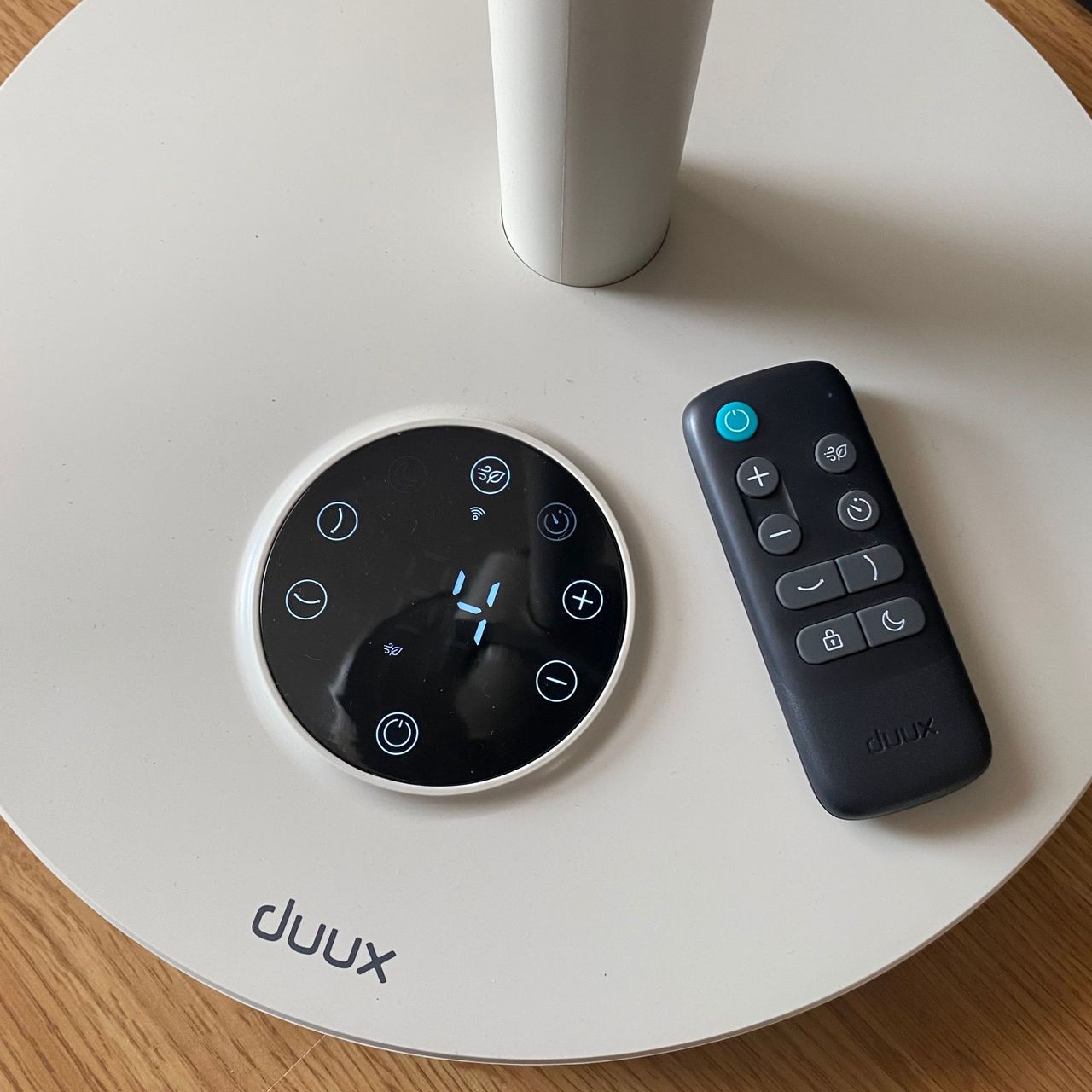 The control panel of the Duux Whisper Flex 2 with the remote control laying next to it
