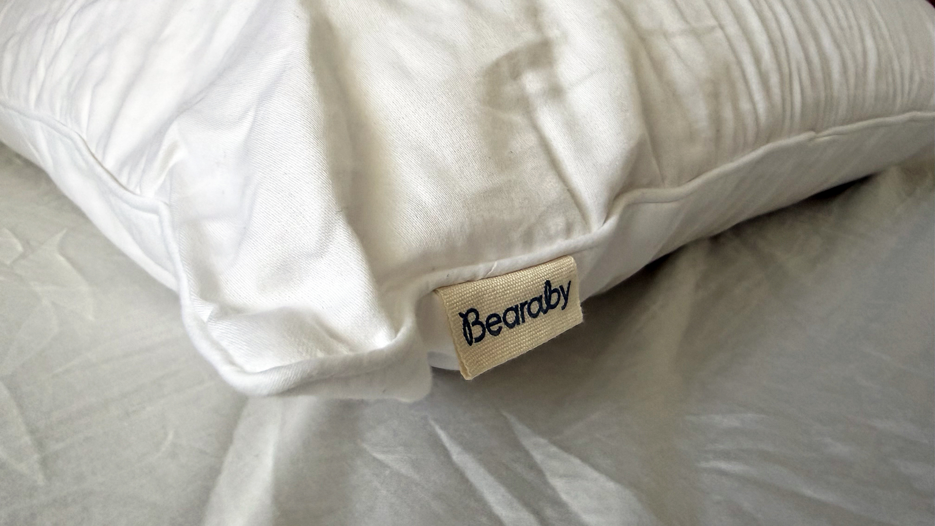 A close up of the Bearaby SoftForm Pillow tag on the side of the pillow