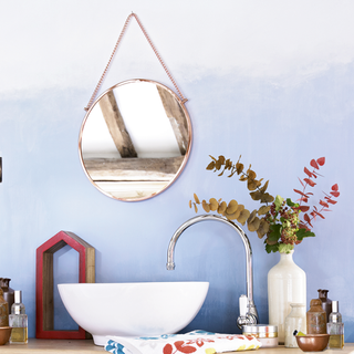bathroom with mirror and blue wall