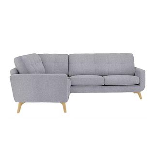 A grey corner sofa with wooden legs