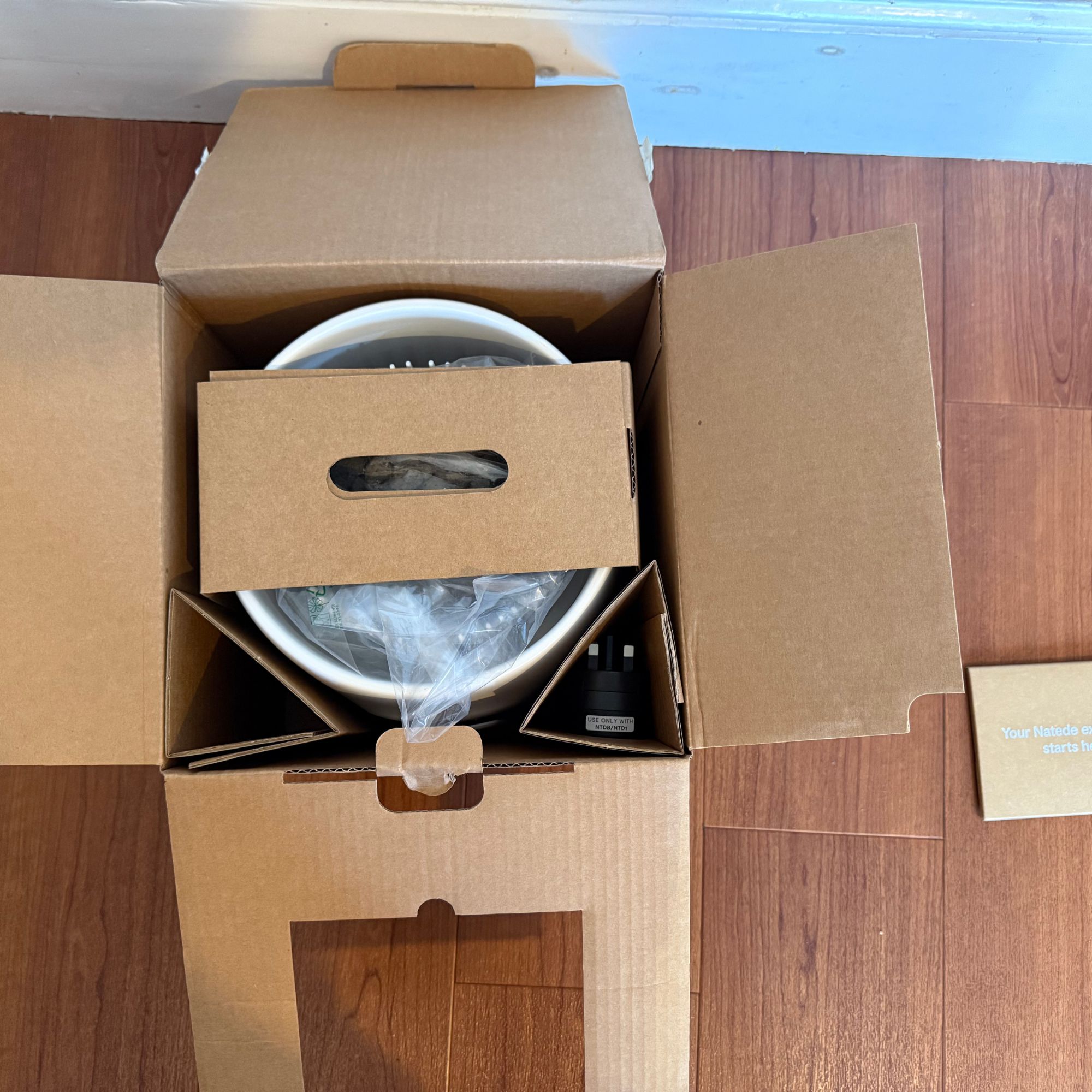 unboxing the Vitesy Natede Smart air purifier on wooden flooring