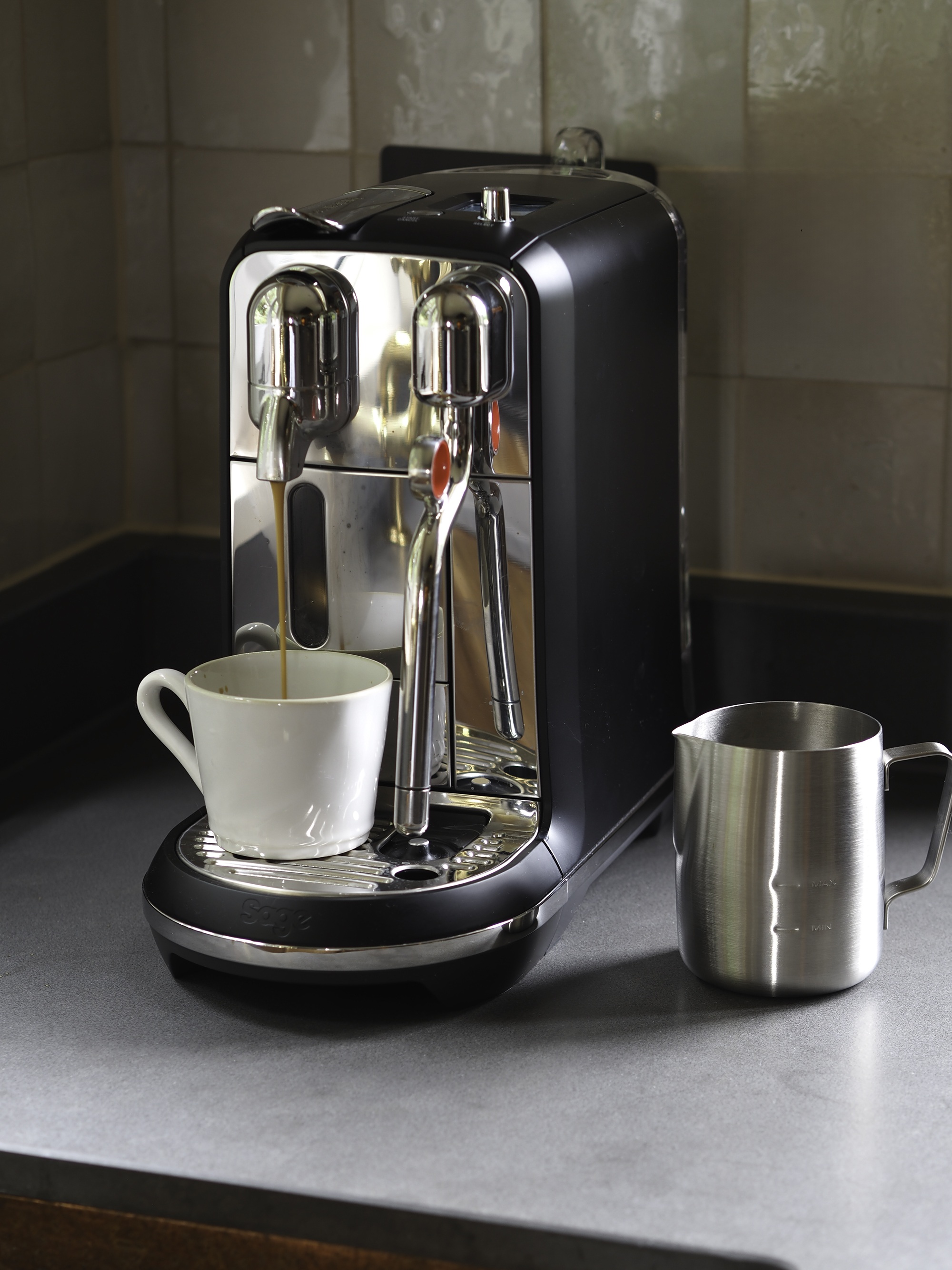 Close up of nespresso creatista plus by sage, being used to make a coffee