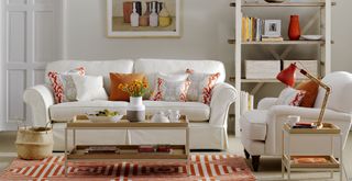 neutral living room with orange accent colours to support Kelly Hoppen's accent colour styling tip