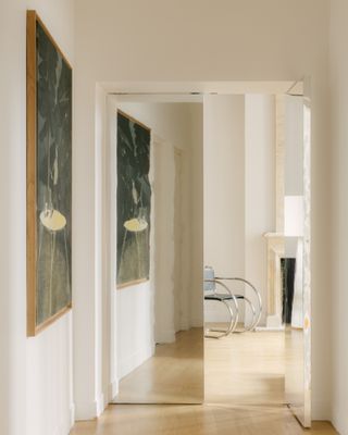 View of corridor with a mirror and art of the Le Marais apartment by Saba Ghorbanalinejad