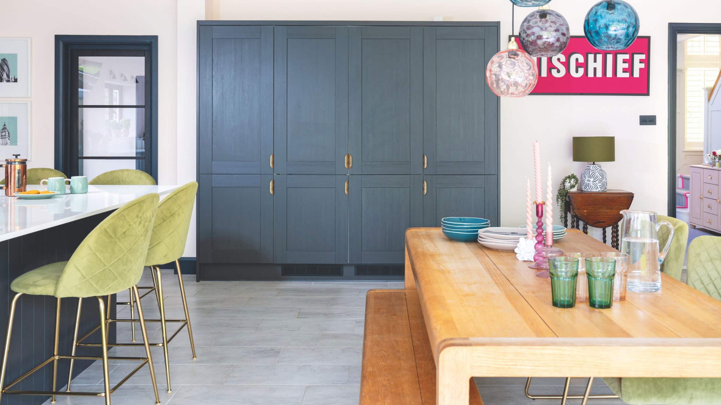 open plan kitchen-diner with large blue cupboards at the back of the room