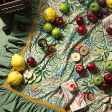 habitat x sanderson & national trust tablecloth with apples, napkins and lemons on top.