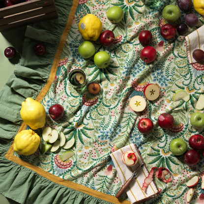 habitat x sanderson & national trust tablecloth with apples, napkins and lemons on top.