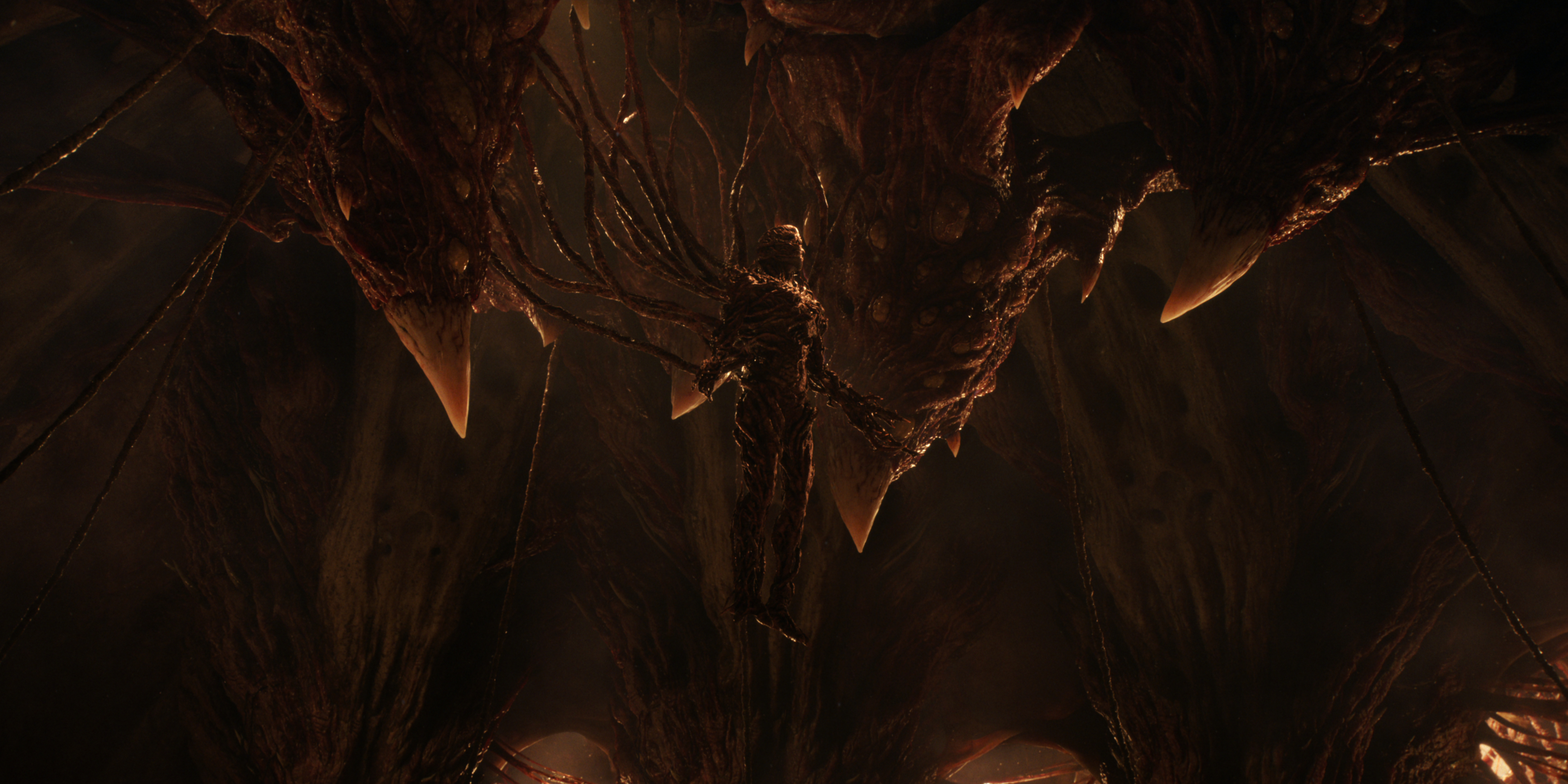 Jamie Campbell Bower as Vecna suspended from a cave and connected to the mind flayer in Stranger Things: Season 5