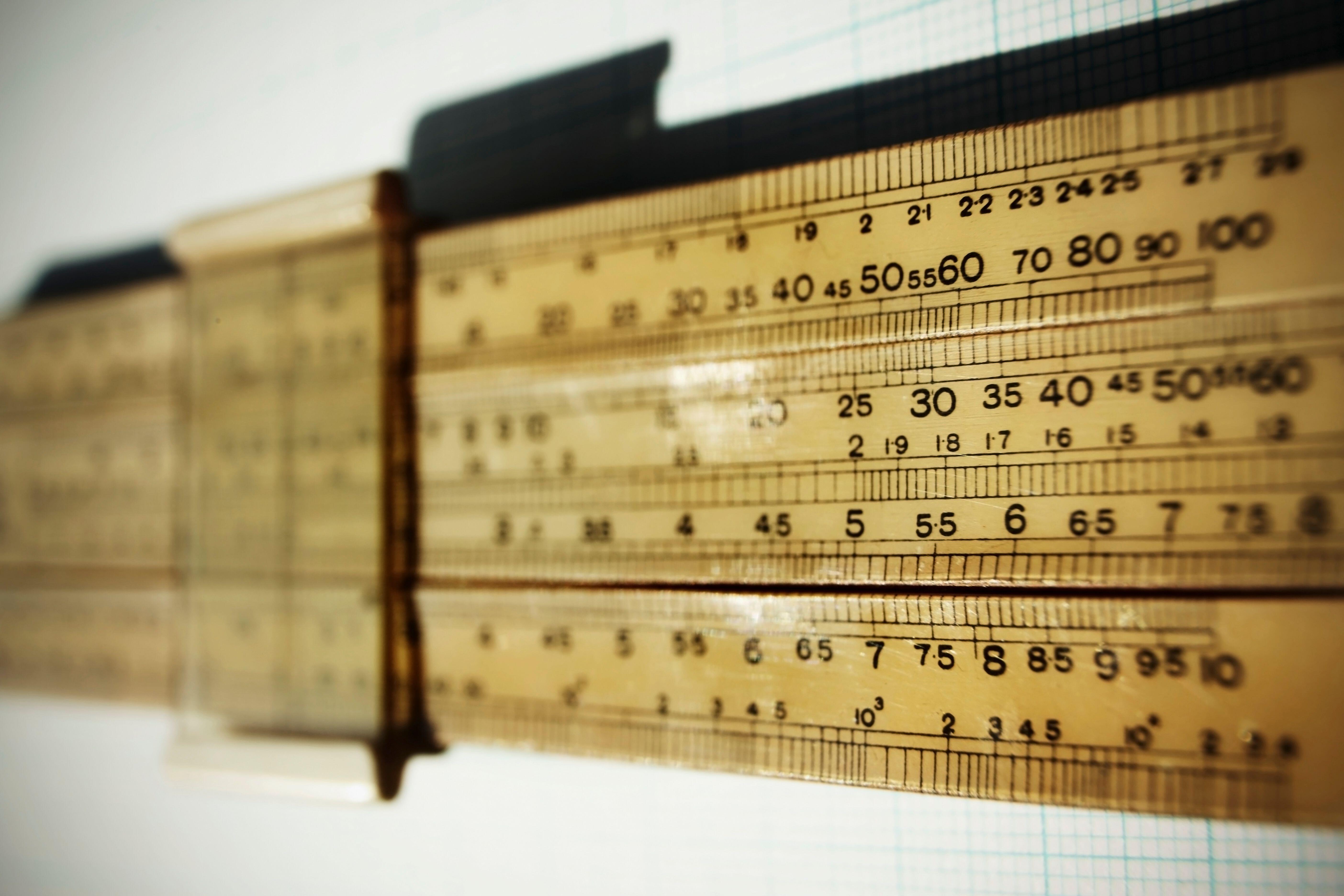 Logarithmic slide rule on piece of graph paper.